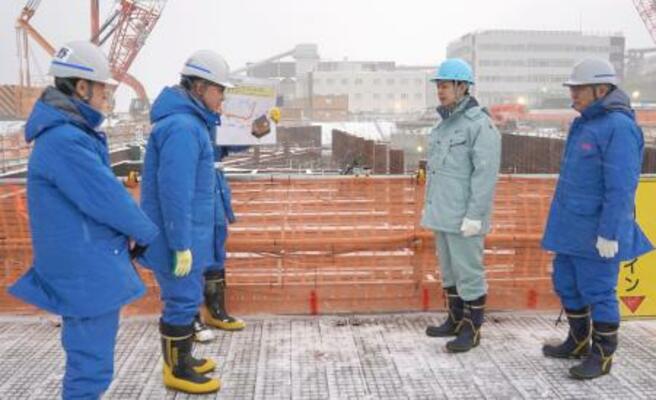 北海道電力泊原発の防潮堤工事現場を視察する北海道の鈴木直道知事(右から2人目)。右端は北海道電の斎藤晋社長=4日午後(北海道電力提供)