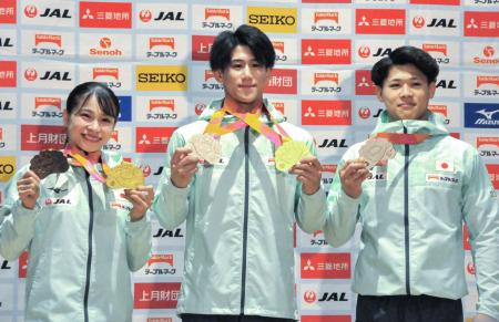 　体操の世界選手権で獲得したメダルを手にする（左から）女子の杉原愛子、男子の橋本大輝と角皆友晴＝２７日、東京都新宿区